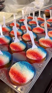 1.5M views · 40K reactions | Red, white, & beautiful Snow Cone Cupcakes!  Here is a behind-the-scenes look into the process of how these treats are made! 療 Chocolate and vanilla cupcakes are covered in buttercream icing, dunked in sugar crystals, airbrushed with festive colors, and topped with a little spoon. The perfect sweet for this weekend! ❤️ | Dorothy Lane Market | Facebook