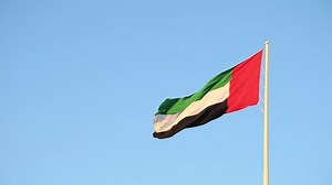 UAE flag waving in the sky, national symbol of UAE. UAE National Day. UAE flag day.
