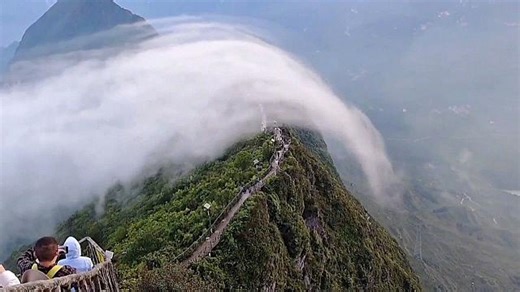 Rare 'cloud waterfall' engulfs mountain path in China