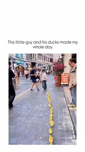 Stranger learn | The video captures a young boy in baggy jeans waddling down a vibrant Chinese pedestrian street, trailed by a precise line of over 50... | Instagram