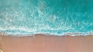clip-1052792870-aerial-top-view-ocean-blue-waves-break