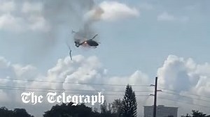 Watch: Helicopter on fire crashes into building in Florida