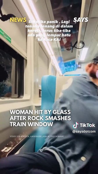 A viral video from Indonesia captures the shocking moment a woman filming herself reading on a train was suddenly showered with glass shards as the window next to her shattered. It was later revealed that someone had thrown a rock at the train, breaking the window. The woman sustained minor facial injuries from the flying glass but is reportedly recovering well. Follow @saysdotcom for more news updates. 🎥: @/widya_anggraini_awaw (Instagram) #SAYSnews