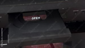 Inserting a CD in a hi-fi equipment.