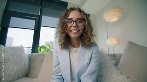 Head shot portrait young smart woman talk to webcam participating in videoconference. Girl negotiating with clients remotely using internet tech connection. Video call, remote work or study concept 4K