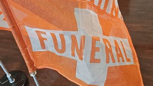 What do I do when driving near a funeral procession?