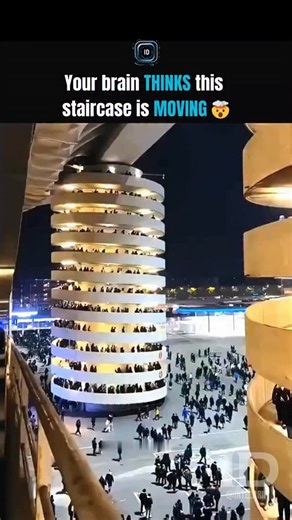 Intel Drip™ | Tech • Engineering • Tools • AI on Instagram: "Your eyes aren’t malfunctioning. They’re doing exactly what they evolved to do. The human visual system doesn’t measure absolute motion. It measures relative motion. When hundreds of people move in the same direction, at similar speed, your brain looks for a stable reference point. When it can’t find one, it assigns motion to the largest object in the frame. In this case: the building. Your brain assumes: people are moving → normal bac