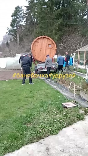 Transporting a Large Wooden Sauna in a Backyard