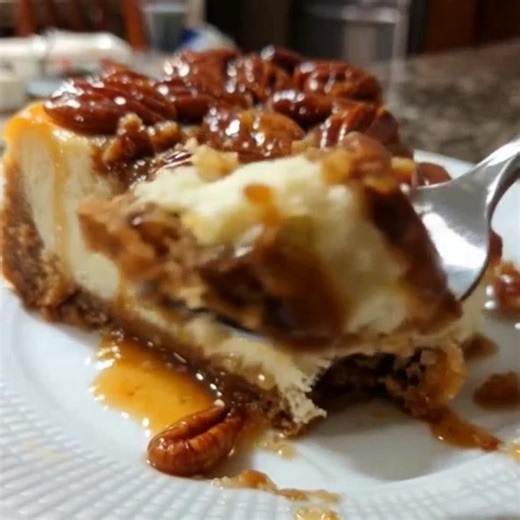 🥧 PECAN PIE CHEESECAKE 💣 FACEBOOK POST: 🥧 This PECAN PIE CHEESECAKE is UNREAL! 😱 Two iconic desserts in ONE! Creamy cheesecake on a graham cracker crust, topped with gooey pecan pie filling and drizzled with caramel... This is Thanksgiving PERFECTION! 🤤 ✨ Best of both worlds! ✨ Pecan pie topping ✨ Showstopper dessert! 👇 RECIPE BELOW 👇 INGREDIENTS: CRUST: 2 cups graham cracker crumbs ⅓ cup melted butter ¼ cup sugar CHEESECAKE: 24 oz cream cheese, softened 1 cup sugar 3 eggs 1 cup sour crea