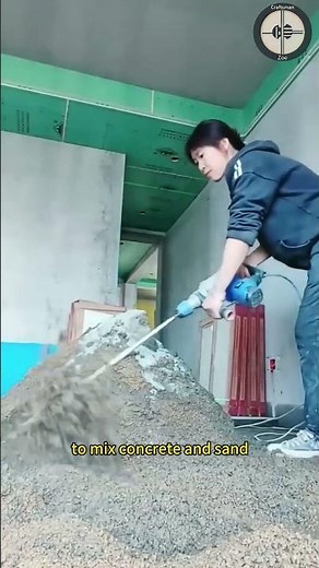 Workers use handheld mixers to mix concrete and sand