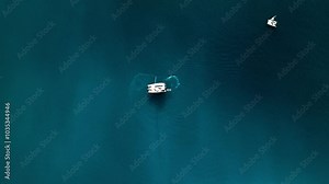 Aerial view of beautiful yachts and a speedboat sailing in the deep blue ocean, Whitsundays, Australia.