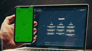 Phone with chroma key green screen with man working with chat gpt bot AI online, connecting with AI and using a chat GPT. IT engineer software developer programmer interact with