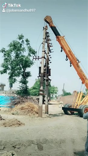 Construction Scene: Crane Lifts Electrical Pole