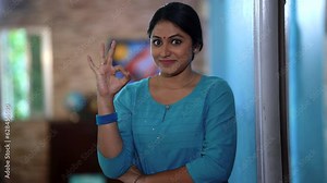 The middle-class woman's face radiates joy, delighted with the finest quality. She expresses approval with a hand gesture, exclaiming, "Very good!"