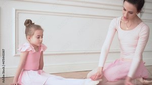Girls dancers in ballet school learns to dance. Little Ballerinas in training in pink dancing suit. Children's ballet school. School of ballet.