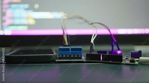 Programming, coding an Arduino microcontroller board to control relays to turn on/off various electrical devices and send action notifications to a smartphone. Internet of Things.