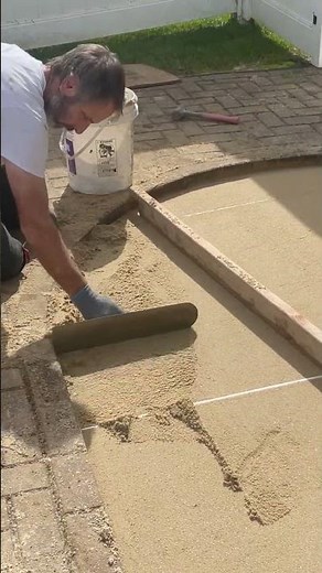 How To Build A Small Brick Patio DIY step 6 Troweling Sand #diy