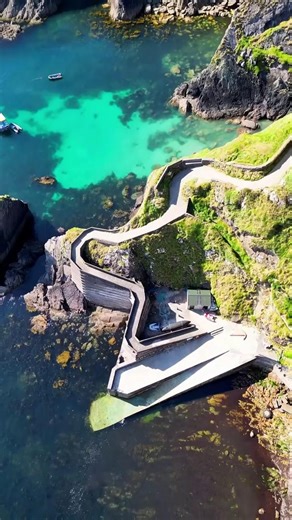 Ireland on Instagram: "Ready to stand at the edge of the world? 🌍🌊 This is Dunquin Pier, County Kerry — one of the most jaw-dropping spots along the Wild Atlantic Way. From above, the winding path looks like a ribbon curling down the cliffs, and at the bottom? Crashing waves, wild ocean views, and major main-character energy. Once the launch point for locals rowing out to the Blasket Islands, it’s now one of the most iconic photo ops in Ireland — and trust us, your camera roll will thank you. 