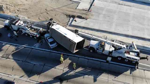 Box truck fell on top of Lexus on the freeway