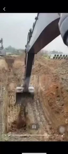 Excavator Digs Deep Trench at Construction Site