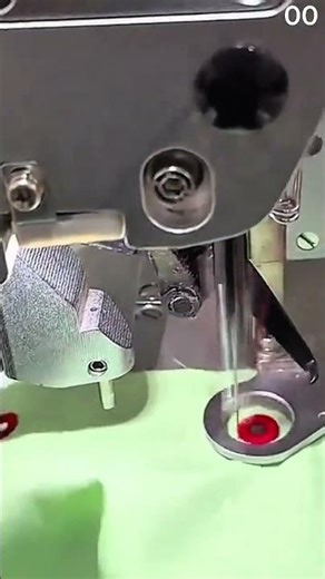 Sewing machine embroiders red circular pattern on green fabric