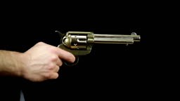 drawing peacemaker gun and shooting three times