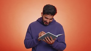 Man making notes, writing down thoughts with pen into notepad notebook diary, to do list, good idea | Premium Stock Video Footage