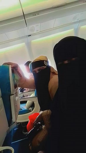 Exploring Airplane Interiors: Passengers in Traditional Attire