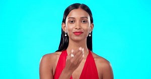 Face, woman and blowing kiss in studio, blue background and backdrop of love, care and flirt. Portrait of happy indian model, hands and kissing emoji for romance, happiness or smile on valentines day