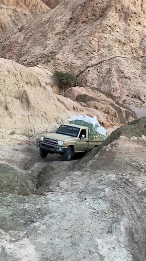 Toyota Pickup Truck Off-Roading in Rocky Terrain