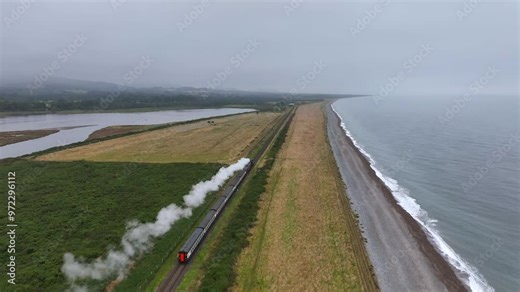 Steam Train, Tinakelly Murragh, County Wicklow, Ireland, September 2024. Drone follows the Dublin Riviera Express pulled by No.131 Steam Locomotive along the coast North towards Greystones.