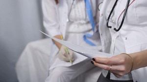 Two Doctors Reviewing Files In Examining Room Stock Footage SBV-337826480 - Storyblocks