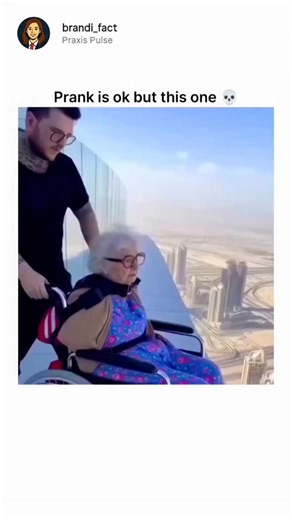 Praxis Pulse on Instagram: "The post shares one of those unbelievable clips that perfectly fits the title, “This video is prank is ok but this…,” because it starts out looking like the most extreme prank ever pulled. A boy carefully straps his grandmother into a reinforced wheelchair fitted with safety harnesses, then — to everyone’s shock — rolls her straight off the edge of a skyscraper rooftop. The moment the wheels reach the edge is pure panic fuel: the city stretches endlessly below, the wi