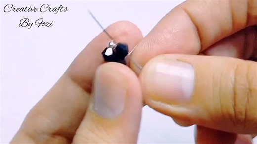 ✨ Earring lovers, it’s your time to shine! 😍 Dive into this DIY gorgeous bicone earrings tutorial and learn to create these stunning black beaded beauties with pearl accents – perfect for beginners! 💎 Hit play, grab your beads, and craft along with me. Tag your sparkle buddy and let’s get those ears popping! #diyjewelry #HandmadeJewelry #beadedearrings #jewelrymaking #diycrafts #beadingtutorial @topfans | Creative Crafts By Fozi