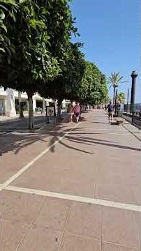 A short walk along the Marbella promenade on a warm summer day