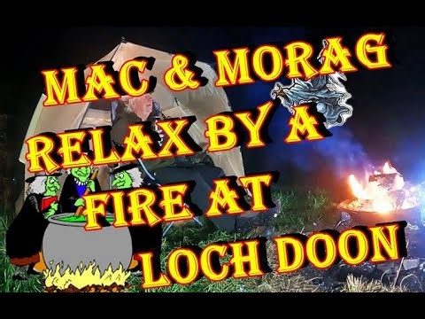 Mac & Morag relax by a fire at Loch Doon