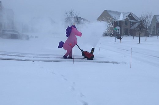 Pink snow-blowing unicorn dances its way though storm
