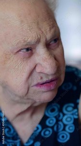 Elderly woman in her 90s looking at someone with a questioning expression