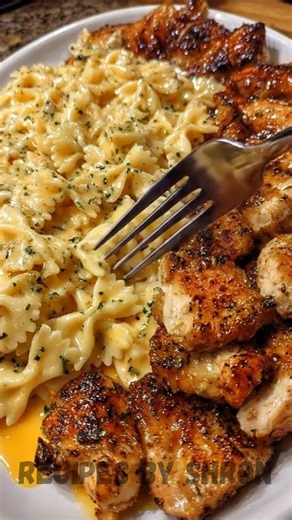 Cajun Garlic Butter Chicken Bowtie Pasta with Creamy Parmesan Sauce Ingredients: • 1 lb boneless, skinless chicken breasts, cut into 1-inch pieces • 1 lb bowtie pasta • 4 tbsp butter, divided • 2 tbsp olive oil • 2 cloves garlic, minced • 1 tbsp Cajun seasoning • 1 tsp garlic powder • 1/2 tsp onion powder • 1/2 tsp Italian seasoning • 1/4 tsp black pepper • 8 oz Velveeta cheese, cubed • 4 oz cream cheese, softened • 1 cup heavy cream • 1/2 cup chicken broth • 1 cup shredded mozzarella • 1/2 cup 