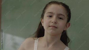 Little girl makes a stop sign with her hand and says stop to social distance, virus,violence, abortion, corruption,inequality,harassment. Unhappy grumpy girl holding stop pose with hand, refusing ban.