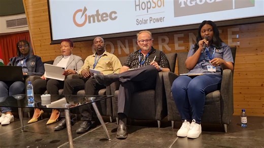 Powering Safety, Protecting Lives. A panel discussion is currently underway at the 14th Annual Technical Conference of the Association of Electricity Distribution Utilities in Namibia (AEDU) at The Dome, Swakopmund. The panel includes Ms. Saarti Shaalukeni, an Engineer at NamPower, Ms. Miriam Kondjeni, Executive HR at NORED, Mr. Leon Hanekom, Executive Manager of Technical Services at Oshakati Premier Electric, Mr. Sibiso Mabuna, Senior Health and Safety Officer, and Ms. Yvonne Nghilumbwa, a Hea