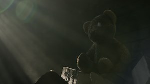 Dirty Damaged Teddy Bear Toy on a Pile of Bricks and Concrete and Sun Rays Coming From a Window