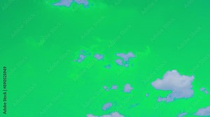 The green screen of moving white clouds with 4K resolution. Can use to change the background color.