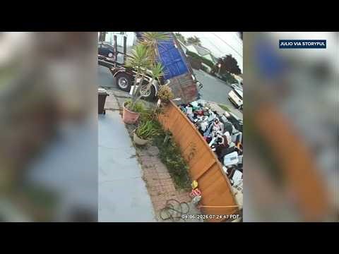 Dump truck pours entire trash load into yard after payment dispute
