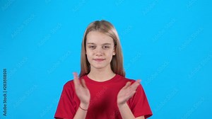 Happy girl claps her hand and shows hand the sign of thumbs up. Slow motion