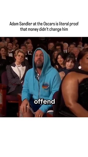 Funvexa on Instagram: "The post features a clip from the 2026 Oscars where host Conan O'Brien ribs Adam Sandler for his casual hoodie-and-shorts attire during the monologue, leading to Sandler's playful banter and a shout-out to Timothée Chalamet, underscoring his unchanged, laid-back persona amid Hollywood glamour. Sandler's appearance echoes his early career style from SNL and films like "Happy Gilmore," contrasting sharply with the formal event; a 2023 Forbes estimate pegged his net worth at 
