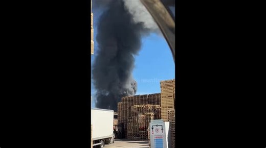Heavy black smoke rises from factory fire in Trafford Park, Manchester, UK