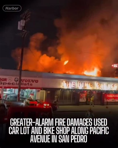 A large fire broke out Tuesday night along the 1600 block of South Pacific Avenue in San Pedro, damaging a used car dealership and a nearby bicycle shop. Los Angeles Fire Department crews were called out around 9 p.m. and quickly upgraded the response to a greater-alarm fire as flames spread through the structure. Firefighters eventually shifted to a defensive strategy, attacking the fire from outside due to unsafe conditions inside the building. Officials say lithium-ion batteries and other mat