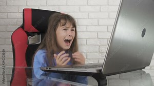 Shock child at the computer. Fear on the Internet. The little girl is horrified by what she sees in the laptop monitor. Child's uncontrolled internet. Stock Video