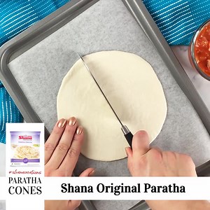 Shana Paratha Cones Recipe!😍 Cut Shana Paratha in half. Add refried beans, tomatoes, red onions, cheese. Roll it up into a cone shape. Place the cones on top of each other and add lots of cheese! Cook in the oven at 140C for 30 mins. Enjoy!!😋 | Shana Foods UK